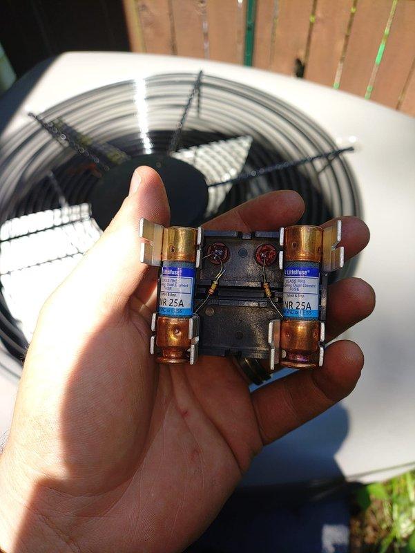 Completed installation of new HVAC system including furnace and air conditioning unit. Connected customer-supplied electrical wiring to new outdoor disconnect equipped with 25-amp dual fuses, finalizing the electrical connection for the AC condenser unit positioned on concrete pad against exterior wall.