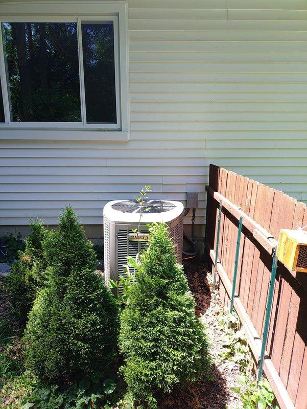 Completed installation of new HVAC system including furnace and air conditioning unit. Connected customer-supplied electrical wiring to new outdoor disconnect equipped with 25-amp dual fuses, finalizing the electrical connection for the AC condenser unit positioned on concrete pad against exterior wall.