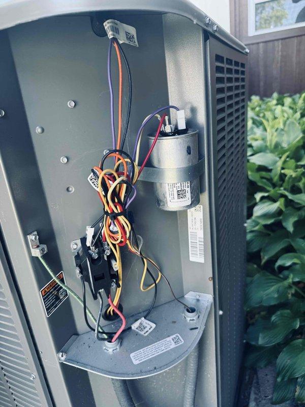 Responded to service call for air conditioning unit running continuously without cycling off, resulting in overcooling of residence. System approximately one year old. Upon arrival, performed diagnostic evaluation of outdoor condensing unit and associated electrical components. Removed access panel and inspected contactor, capacitor, and control wiring for proper operation and connections. Verified all electrical connections at contactor relay were secure and tested capacitor functionality. Assessed thermostat communication and control circuit operation to determine cause of continuous compressor operation. Identified and resolved issue preventing system from responding to thermostat call for cooling termination. Restored normal cycling operation with proper temperature control. System tested and verified cycling on and off appropriately per thermostat settings.