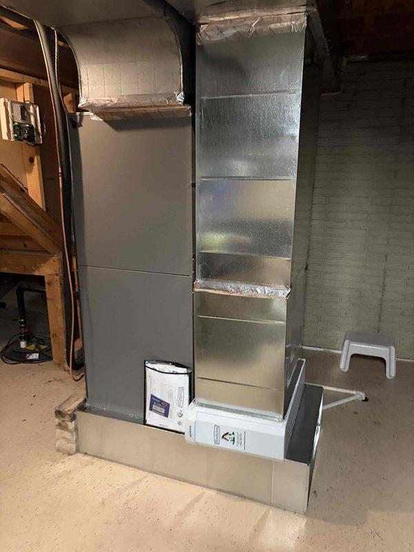 Completed full installation of fully modulating heat pump system with air handler and S40 thermostat in residential basement location. System was properly configured for modulating operation, all ductwork sealed and insulated with reflective material, and thermostat programmed to optimize variable-speed compressor and air handler performance for maximum efficiency and comfort control.