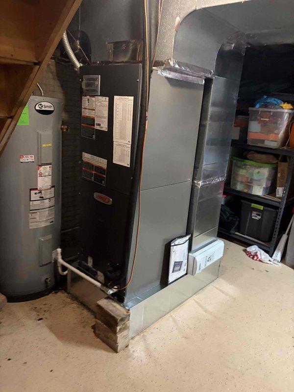 Completed full installation of fully modulating heat pump system with air handler and S40 thermostat in residential basement location. System was properly configured for modulating operation, all ductwork sealed and insulated with reflective material, and thermostat programmed to optimize variable-speed compressor and air handler performance for maximum efficiency and comfort control.
