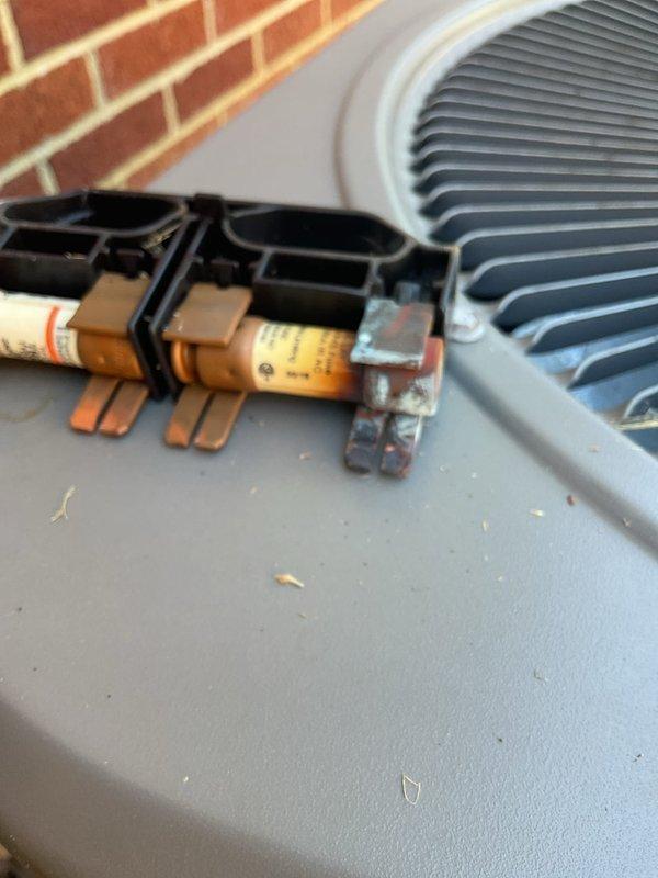 Responded to no cooling complaint on residential air conditioning system. Upon inspection, found blown fuses in outdoor disconnect. Replaced defective fuses and restored power to condenser unit, returning system to normal cooling operation.