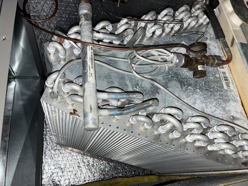 # HVAC Maintenance - Cooling

Performed standard cooling season maintenance on one-year-old air conditioning system. Upon arrival, completed visual inspection of outdoor condensing unit and indoor air handler components.

During inspection of indoor evaporator coil, discovered significant frost and ice buildup across entire coil assembly, including heavy accumulation on refrigerant tubing and aluminum fins. This abnormal condition indicated restricted airflow or potential refrigerant issue requiring immediate attention beyond standard maintenance scope.

Inspected blower wheel assembly and found moderate dust accumulation on pleated blades, which was contributing to reduced airflow and likely causing the coil icing condition. Removed and thoroughly cleaned blower wheel to restore proper air circulation through the system.

Addressed the frozen evaporator coil by shutting down cooling mode and allowing complete defrost cycle. Verified all supply registers were open and unobstructed. Che