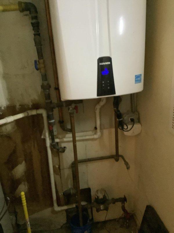 Performed complete descaling maintenance service on an 8-year-old tankless water heater located in hallway utility closet. Flushed unit with descaling solution to remove mineral buildup and restore optimal heating efficiency. Verified all plumbing connections, inspected control panel operation, and confirmed proper system function upon completion.