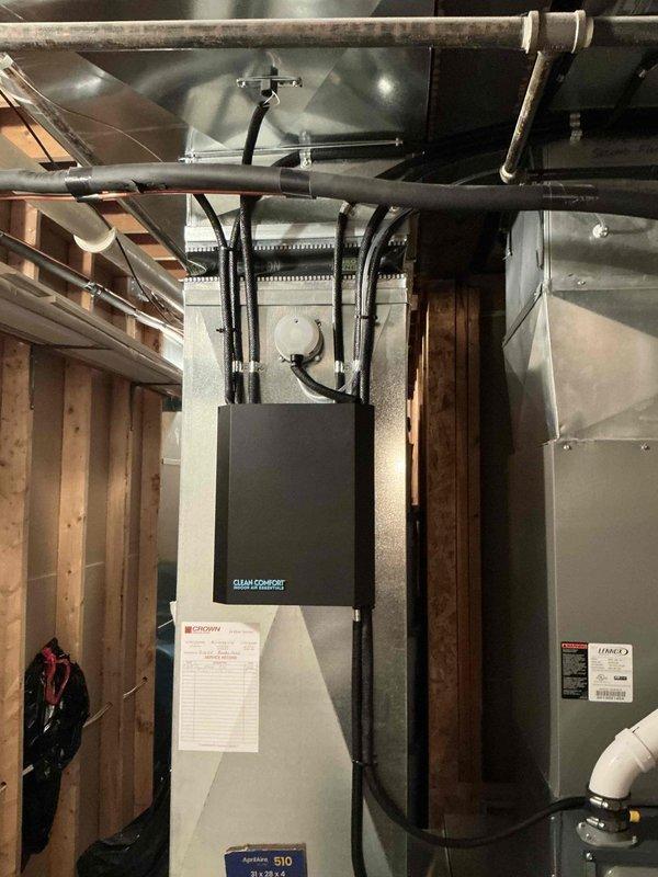 Conducted on-site evaluation of existing 13-year-old air conditioning system to provide replacement estimate. Assessed current HVAC equipment configuration including furnace, ductwork, and condensing unit accessibility. Documented existing installation setup in basement mechanical room, photographed Challenge brand air handler unit with connected ductwork, Lennox furnace cabinet, PVC condensate drainage lines, and exposed framing to determine proper sizing and installation requirements for new AC system replacement.