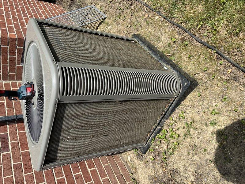 Completed MVP cooling maintenance visit on 2-year-old air conditioning system. Performed visual inspection of outdoor condenser unit, noting accumulated dirt and debris on protective grilles and coil surfaces. Conducted electrical diagnostics using digital multimeter to verify proper voltage and amperage readings at control components and contactors. System operating within normal parameters following routine maintenance procedures.