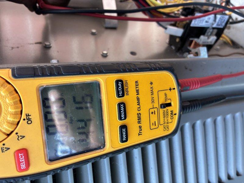 Completed MVP cooling maintenance visit on 2-year-old air conditioning system. Performed visual inspection of outdoor condenser unit, noting accumulated dirt and debris on protective grilles and coil surfaces. Conducted electrical diagnostics using digital multimeter to verify proper voltage and amperage readings at control components and contactors. System operating within normal parameters following routine maintenance procedures.