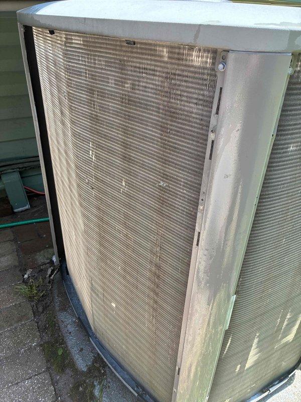 Completed MVP preventive maintenance visit on 7-year-old cooling system. Performed comprehensive inspection of outdoor condenser unit, which showed moderate weathering and accumulated debris on exterior fins and louvers with visible dirt, grime, and algae growth on cabinet panels. Inspected internal control board and electrical components, noting all connections secure and circuit board operational with normal dust accumulation for unit age. System tested and confirmed operational within manufacturer specifications.