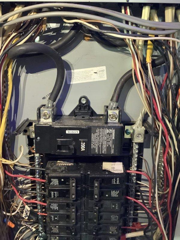 Responded to service call for fraying upper entrance electrical cable requiring replacement estimate. Upon inspection, discovered electrical panel with significant safety concerns including extensive rust and corrosion damage throughout the lower portion of the enclosure, indicating prolonged moisture exposure. The service entrance cable showed signs of deterioration with fraying conductors at the connection point. Panel contained multiple circuit breakers with dense wiring bundles entering from the top, with various colored conductors including black, red, white, yellow, and purple wires. The corrosion had compromised the integrity of the metal enclosure base plate where circuit breakers are mounted, creating potential safety hazards. Documented existing conditions with photographs showing the corroded panel box, deteriorated service entrance cable connections, and overall electrical system configuration. Provided comprehensive estimate for complete service entrance cable replacement 