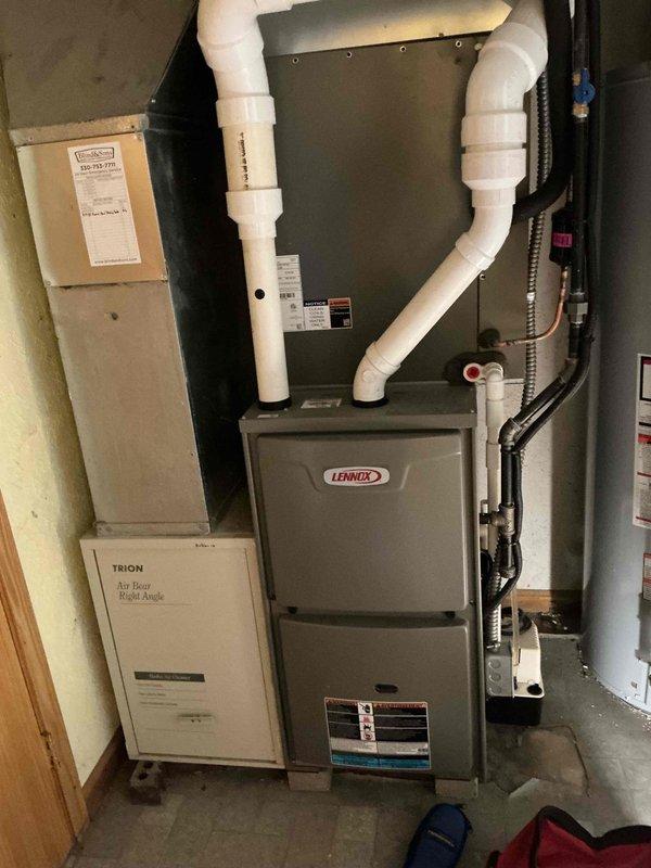 Completed BS-MVP cooling maintenance visit on a 2-year-old residential HVAC system. Performed comprehensive inspection of indoor Lennox furnace unit with connected air handler and Trion Air Bear filtration system, verifying all components, connections, and PVC exhaust/intake piping. Inspected outdoor condenser unit, checked refrigerant lines, electrical connections, and confirmed proper operation of fan assembly and coil access panels. All equipment operating within normal parameters with no issues identified.