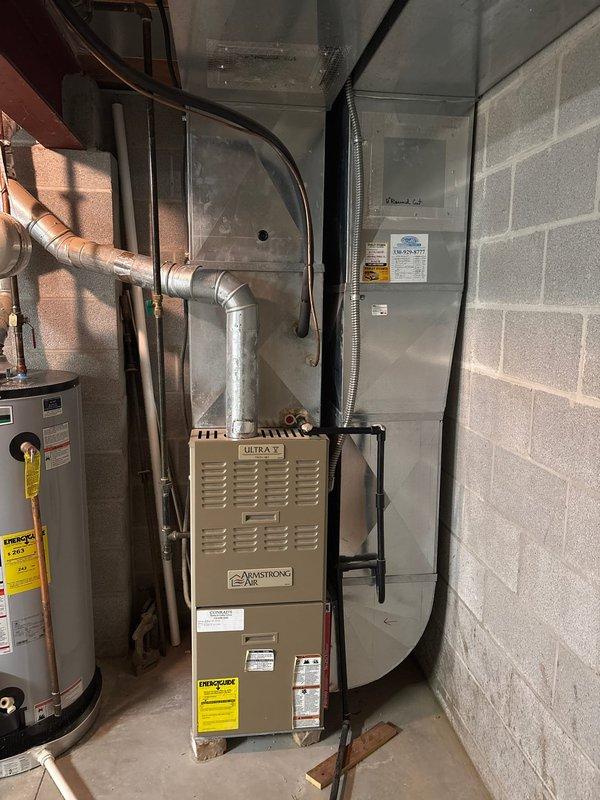 Completed full HVAC system installation including an 80% efficiency Armstrong Ultra X furnace and air conditioning unit in residential basement mechanical room. Installed new equipment with proper ductwork connections, electrical components including 25-amp fuses, copper refrigerant lines, and all necessary safety controls. System tested and verified operational upon completion.