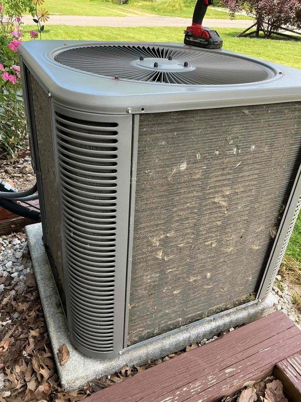 Completed preventive maintenance cooling visit on 5-year-old residential air conditioning system. Performed comprehensive inspection of outdoor condensing unit, verified electrical readings with multimeter showing 122.5V supply voltage and 53.5 MFD capacitance within acceptable range, and documented equipment condition with service photos. Unit operating properly with normal parameters confirmed.