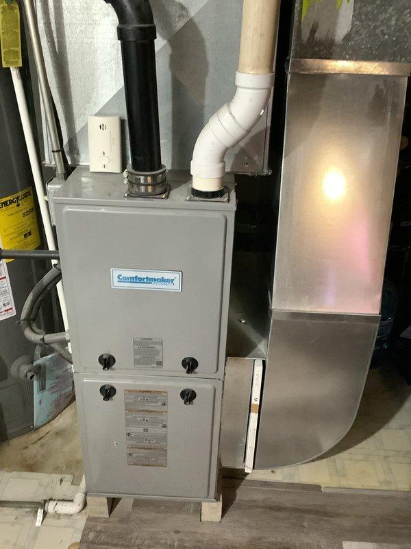 Provided comprehensive HVAC system replacement estimate for a twinplex property experiencing no cooling condition. Assessed existing Comfortmaker furnace installation in basement utility area, evaluated current ductwork configuration including metallic supply plenum and flexible duct runs, and documented PVC exhaust venting system. Documented equipment specifications, spatial constraints, and existing infrastructure to develop accurate replacement proposal for complete air conditioning system installation.