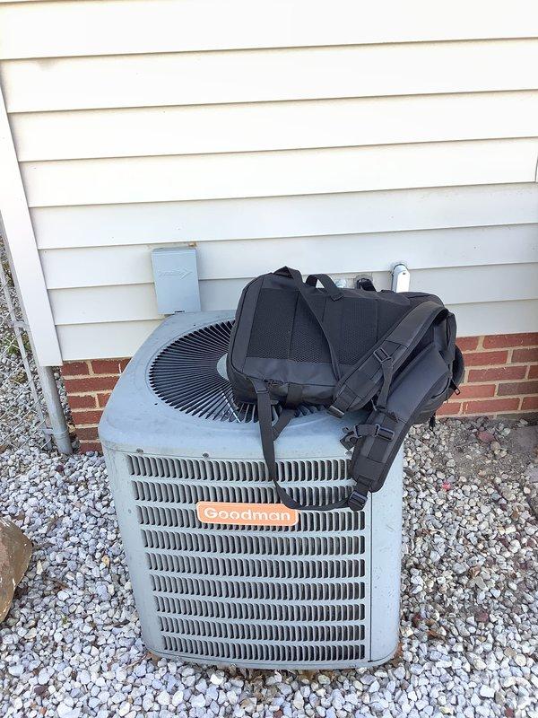 Performed comprehensive evaluation of existing HVAC system for replacement estimate. Assessed 40-year-old furnace and non-operational air conditioning condenser unit. Documented existing Goodman brand outdoor condenser installation, electrical disconnect, and drainage system configuration. Evaluated equipment placement, gravel pad condition, and electrical service connections to provide accurate replacement recommendations for complete heating and cooling system upgrade.