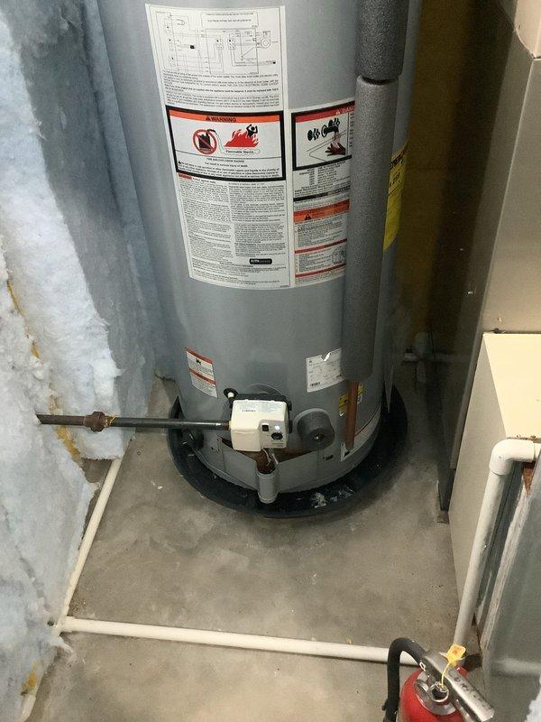 Completed water heater replacement in residential utility room. Removed existing unit and installed new A.O. Smith ProLine tanked water heater with proper plumbing connections, expansion tank, drain pan, and temperature control assembly. All copper and PVC piping configured to code specifications with system tested and operational upon completion.