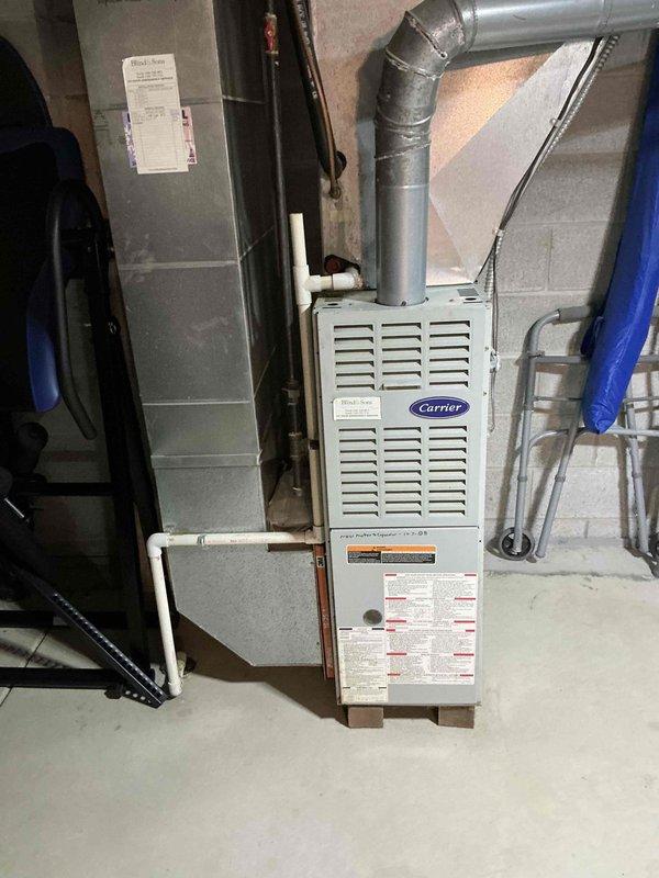 Conducted on-site assessment of 26-year-old Carrier furnace and air conditioning system in residential basement mechanical room. Evaluated existing equipment condition, measured system specifications, and documented installation configuration including ductwork, venting, electrical connections, and condensate drainage components. Provided comprehensive replacement estimate for complete HVAC system upgrade, documented equipment with photographs, and submitted quote for customer review and approval.
