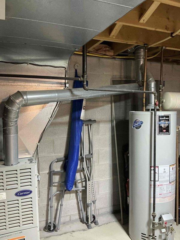 Conducted on-site assessment of 26-year-old Carrier furnace and air conditioning system in residential basement mechanical room. Evaluated existing equipment condition, measured system specifications, and documented installation configuration including ductwork, venting, electrical connections, and condensate drainage components. Provided comprehensive replacement estimate for complete HVAC system upgrade, documented equipment with photographs, and submitted quote for customer review and approval.