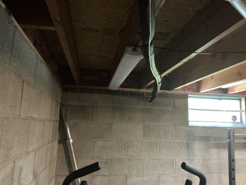 Conducted comprehensive HVAC system assessment for replacement estimate on 12-year-old air conditioning unit in residential property. Evaluated existing equipment, ductwork configuration in unfinished basement area, and overall system performance to provide multiple replacement options. Documented current installation including flexible ductwork routing, supply registers, and equipment accessibility for proper sizing and installation planning of new system.
