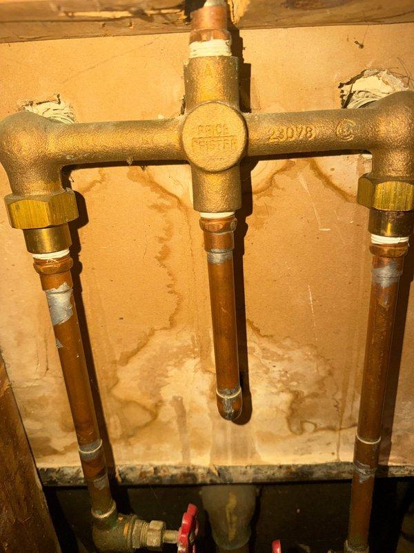 Responded to service call for leaky bathtub with worn fixtures. Inspected existing Price Pfister three-handle tub and shower valve assembly showing significant age-related deterioration, mineral buildup, and corrosion on trim components. Replaced all three corroded handle assemblies and trim pieces to restore proper operation and eliminate leak at fixtures. Verified water supply shutoffs functioning properly at copper supply lines. Tested repaired system for proper hot and cold water control and confirmed no active leaks at valve stems or spout connection upon completion.