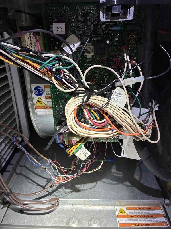 Completed routine MVP cooling maintenance visit on HVAC system. Performed comprehensive inspection of outdoor condensing unit and indoor air handler components. Inspected MARS 370VAC dual-run capacitor for proper operation and connections, verified all electrical terminations at capacitor terminals with multiple wire connections secure and properly seated. Examined control box wiring harness including 120V igniter circuit, confirmed all multicolored wire bundles properly routed and secured with cable ties. Assessed condition of electronic control boards, contactors, and relay components for signs of wear or failure. Verified refrigerant line connections and copper tubing integrity at equipment base. Noted normal accumulation of environmental debris in outdoor unit, consistent with exterior installation. All electrical components functioning within normal parameters, no immediate repairs required. System operational and ready for continued service.