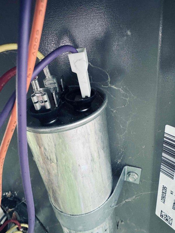 Completed scheduled MVP cooling maintenance visit on 3-year-old air conditioning system. Performed comprehensive system inspection including electrical components and blower assembly. Inspected capacitor with proper wire connections intact on purple, orange, red, and yellow leads with terminal block properly secured. Verified squirrel cage blower wheel operation and motor shaft assembly showing normal wear patterns consistent with system age. All components functioning within normal parameters with no immediate service needs identified.