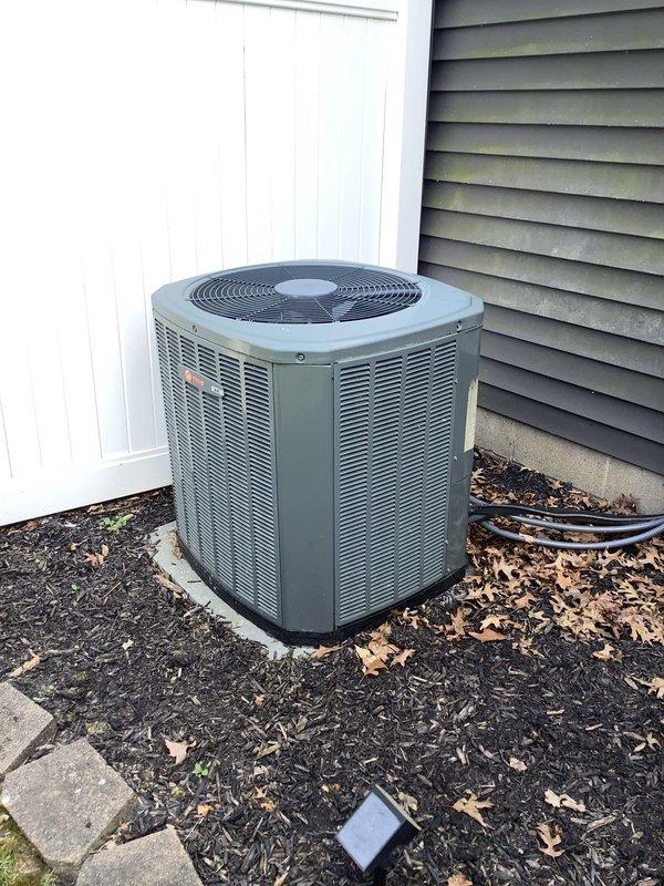 Responded to no cooling call on 10-year-old residential HVAC system with reported condenser malfunction and unusual noise. Upon arrival, inspected outdoor condensing unit and indoor air handler system. Documented equipment condition and configuration, including furnace, evaporator coil unit, and outdoor condenser positioned on concrete pad. Customer enrolled in maintenance program during service visit.