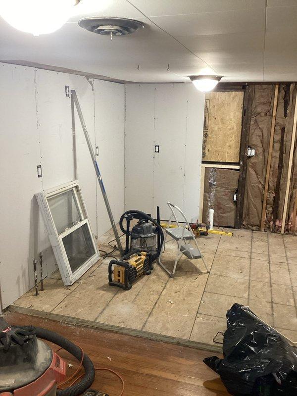 Responded to failed electrical inspection with multiple NEC 2023 code violations requiring correction. Replaced non-fan-rated light boxes in center of habitable rooms per 314.27(c). Installed required nail plates in multiple areas where cable protection was missing per 300.4A1. Added receptacle to 8' living room wall to meet proper wall spacing requirements per 210.52. Re-secured cable stapling throughout multiple areas to comply with 334.30 standards. Located and corrected open splice with equipment ground in wall cavity. Performed complete bathroom electrical rewire for two bathrooms to achieve full 2023 NEC code compliance, as original rough-in was incomplete. Verified all subpanel connections for proper termination and torque specifications. Documented all corrections with photographic evidence showing exposed wall sections, electrical boxes, and ceiling penetrations with visible wiring. Installation held pending re-inspection and manager approval for code compliance verification.