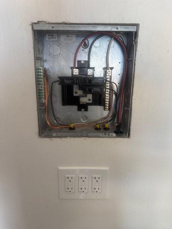 Installed an 8-circuit, 50-amp sub-panel with proper grounding and bonding, complete with circuit breakers and appropriate gauge conductors. Ran and terminated a new dedicated 120V, 20A branch circuit for first-floor use, including installation of receptacle outlets. All work completed to code specifications with proper wire sizing, panel mounting, and secure connections throughout the electrical distribution system.
