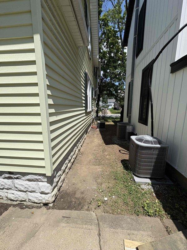 Conducted comprehensive HVAC system evaluation for residential property in preparation for home sale. Assessed existing outdoor air conditioning condenser unit located in side yard utility access area and inspected GE water heater installation in basement utility room, documenting current equipment conditions and specifications to develop replacement estimate quotes for both cooling system addition and complete HVAC system upgrade.