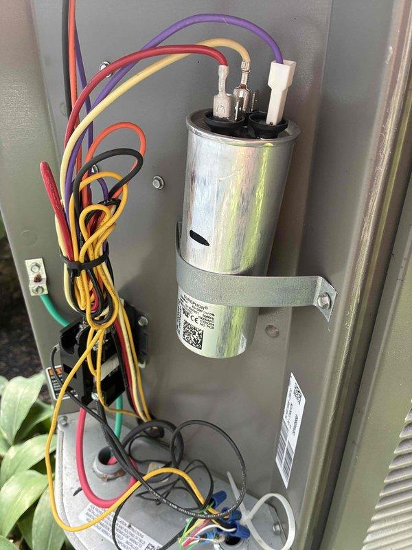 Completed routine cooling maintenance on Lennox air conditioning system. Inspected outdoor condensing unit, verified electrical connections at capacitor and blower motor assembly, and confirmed all wiring terminations were secure with proper color-coded connections intact. System operational and ready for continued service.