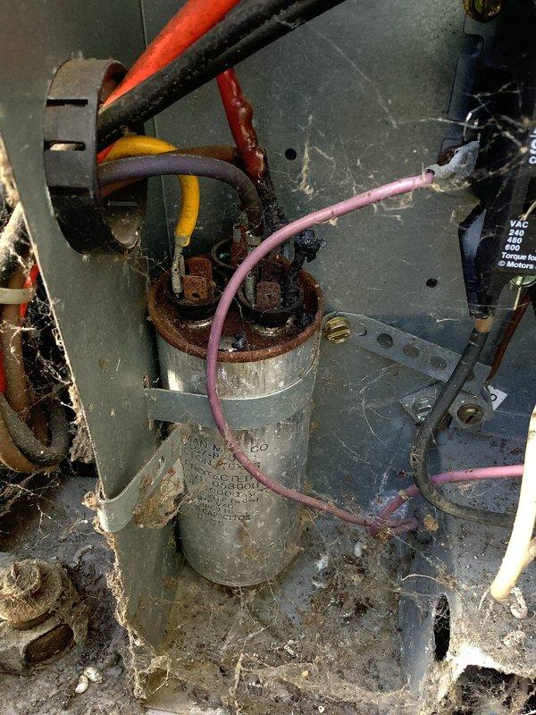 Responded to no cooling complaint on 5-year-old residential air conditioning system. Upon inspection, found heavily corroded dual run capacitor with significant rust buildup on casing and terminals. Capacitor tested faulty and was unable to properly start compressor and condenser fan motor. Replaced failed capacitor with new unit, verified proper microfarad ratings for both compressor and fan circuits, and secured all electrical connections. Cleaned accumulated debris from electrical compartment. System tested successfully with compressor and outdoor fan operating normally, delivering cold air to living space.
