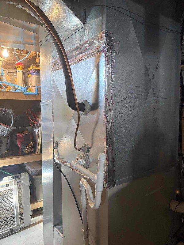 Completed second phase of air conditioning and evaporator coil installation. Performed vacuum test on refrigerant lines using calibrated digital gauge to verify system integrity and ensure proper evacuation before charging. Installed and secured main supply ductwork with metal transition elbow, ensuring proper airflow distribution and structural support with appropriate hangers and straps.