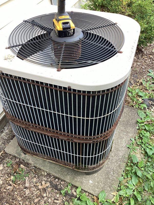 Responded to no cooling complaint on aging residential air conditioning system. Upon arrival, performed diagnostic inspection of outdoor condensing unit. Found severely corroded dual run capacitor with significant rust damage affecting electrical connections. The capacitor showed brown and orange discoloration indicating advanced deterioration from prolonged outdoor exposure. Inspected associated electrical components including contactor and wiring connections. Due to the age of the unit (over 10 years) and advanced corrosion of critical electrical components, documented equipment condition with photos showing the failed capacitor, deteriorated wiring connections, and overall weathering of the outdoor unit cabinet and coil assembly.