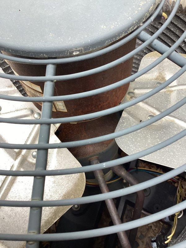 Responded to no cooling complaint on residential air conditioning system. Upon arrival, found outdoor condenser unit with heavily contaminated coil fins, particularly dense accumulation of cottonwood seed fibers and organic debris blocking airflow through approximately 60-70% of the coil surface area on one side. Inspected unit from top access, noting normal wear consistent with outdoor installation but significant debris buildup preventing proper heat transfer. Documented existing conditions including wire connections, condenser coil contamination, and overall unit accessibility. Customer was advised that the extensive coil blockage was likely preventing adequate airflow and refrigerant heat rejection, which could cause the compressor to cycle on high pressure safety or appear non-functional, rather than actual compressor failure. Recommended professional coil cleaning service to restore proper airflow and system operation before proceeding with any component replacement diagnostics.