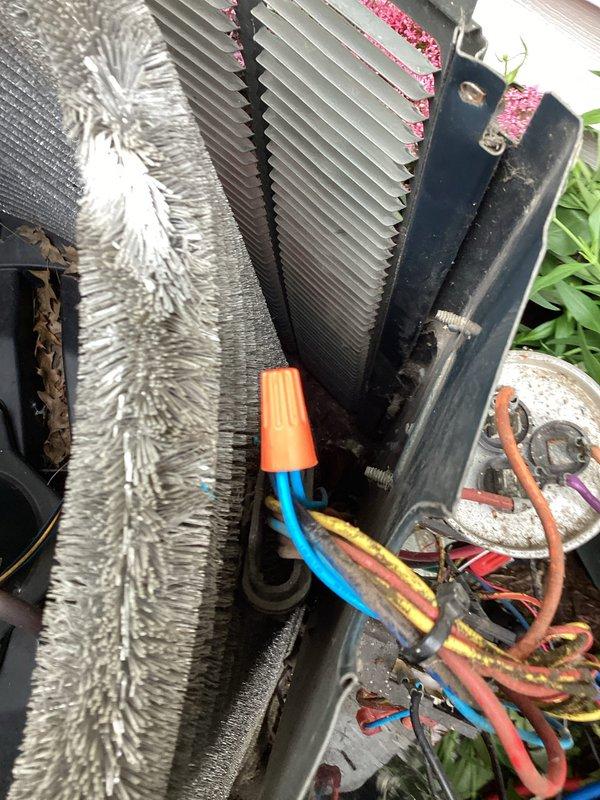 Responded to no cooling complaint on residential air conditioning system. Upon arrival, found outdoor condenser unit with heavily contaminated coil fins, particularly dense accumulation of cottonwood seed fibers and organic debris blocking airflow through approximately 60-70% of the coil surface area on one side. Inspected unit from top access, noting normal wear consistent with outdoor installation but significant debris buildup preventing proper heat transfer. Documented existing conditions including wire connections, condenser coil contamination, and overall unit accessibility. Customer was advised that the extensive coil blockage was likely preventing adequate airflow and refrigerant heat rejection, which could cause the compressor to cycle on high pressure safety or appear non-functional, rather than actual compressor failure. Recommended professional coil cleaning service to restore proper airflow and system operation before proceeding with any component replacement diagnostics.