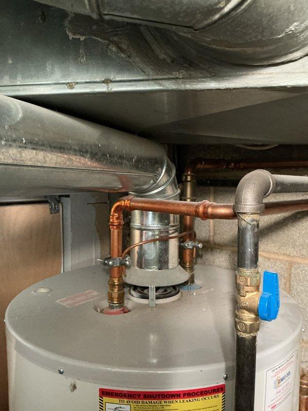 Responded to no-ignition issue on 10-year-old tanked water heater. Upon arrival, performed diagnostic evaluation of gas control system and ignition components. Inspected PCB and electrical connections for potential issues related to recent electrical work performed at property. Tested gas valve operation, thermocouple functionality, and pilot assembly. Verified proper gas supply and pressure to unit. Examined burner assembly and flame sensor for carbon buildup or corrosion that could prevent ignition. Checked all wiring connections and control board for signs of electrical damage or loose connections. Documented existing installation configuration including copper supply lines, brass fittings, and exhaust venting. Water heater showed typical wear consistent with age, including surface oxidation on components and minor corrosion on surrounding fixtures. Completed thorough assessment of ignition failure and provided findings regarding potential PCB involvement related to recent electrica