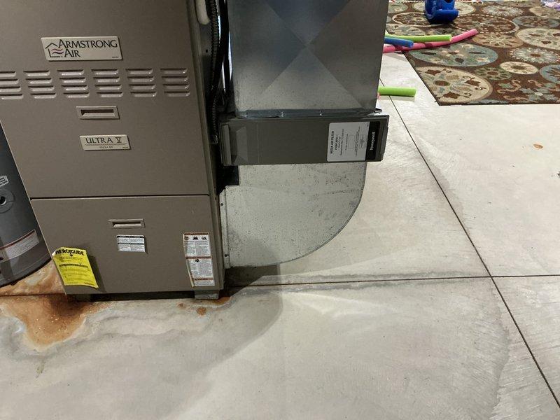 Conducted comprehensive HVAC system evaluation for complete replacement estimate. Assessed existing Armstrong Air furnace/air handler unit installed on residential garage floor and outdoor Armstrong condenser unit positioned on concrete pad adjacent to building foundation. Documented current equipment condition, specifications, and installation configuration including ductwork connections, refrigerant line routing, and electrical service. Evaluated both indoor and outdoor unit performance, noted aging equipment with visible weathering and potential maintenance concerns on outdoor condenser coils. Provided detailed photographic documentation of existing system components and installation environment to support replacement recommendations and equipment sizing requirements.