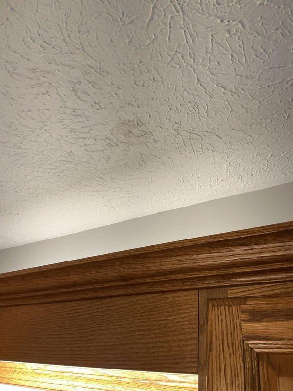 Responded to water leak complaint with visible staining and moisture on kitchen ceiling directly below bathroom. Upon investigation, identified source as compromised bathtub drain assembly and overflow connection causing water infiltration through subfloor. Removed and replaced defective drain gaskets, resealed tub spout connection, and tightened overflow plate assembly to eliminate leakage points. Verified proper drainage function and confirmed no active water penetration to ceiling below.