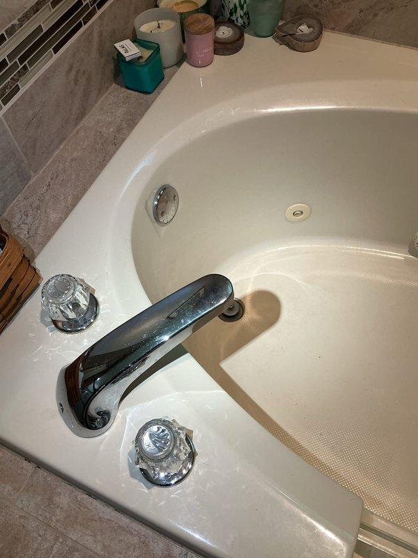 Responded to water leak complaint with visible staining and moisture on kitchen ceiling directly below bathroom. Upon investigation, identified source as compromised bathtub drain assembly and overflow connection causing water infiltration through subfloor. Removed and replaced defective drain gaskets, resealed tub spout connection, and tightened overflow plate assembly to eliminate leakage points. Verified proper drainage function and confirmed no active water penetration to ceiling below.