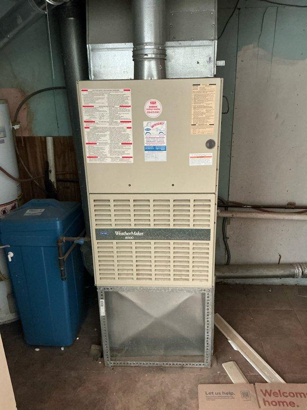 Conducted comprehensive on-site evaluation for complete HVAC system replacement of existing WeatherMaker 8000 furnace and air conditioning unit in residential basement mechanical room. Documented current equipment configuration including ductwork connections, electrical requirements, and clearance specifications, photographed existing installation showing furnace with horizontal ventilation slats, metallic supply ductwork, and adjacent blue pressure tank with associated piping. Provided detailed replacement estimate covering removal of existing equipment and installation of new high-efficiency heating and cooling system with proper sizing calculations based on home requirements.