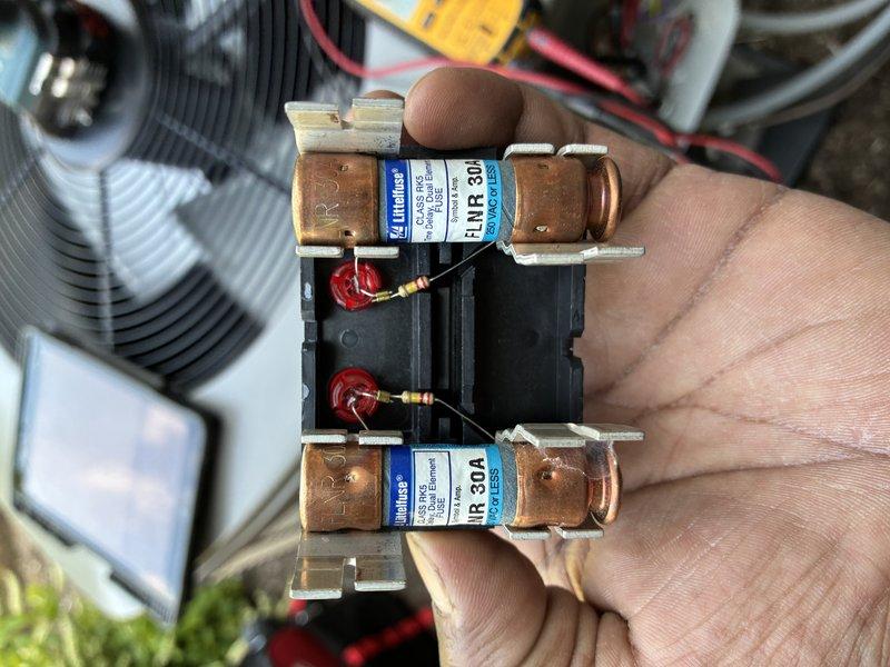 Completed comprehensive MVP cooling maintenance on residential air conditioning system. Performed electrical diagnostics using digital multimeter to verify proper voltage and amperage readings across system components. Inspected and tested 30-amp Littelfuse cartridge fuses on fuse block, confirming proper amperage rating and secure mounting in spring clips. Verified electrical connections and safety components are functioning within manufacturer specifications. All measurements recorded normal operating parameters. System tested and operating efficiently with no deficiencies noted.