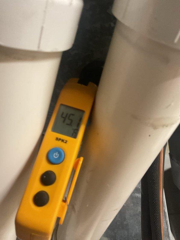 Completed preventive maintenance cooling visit on 8-year-old residential air conditioning system. Inspected outdoor condenser unit, verified proper operation of fan assembly and protective guard, confirmed unit is level on concrete pad with adequate gravel drainage, and measured system performance parameters registering 45 degrees, indicating normal cooling operation.