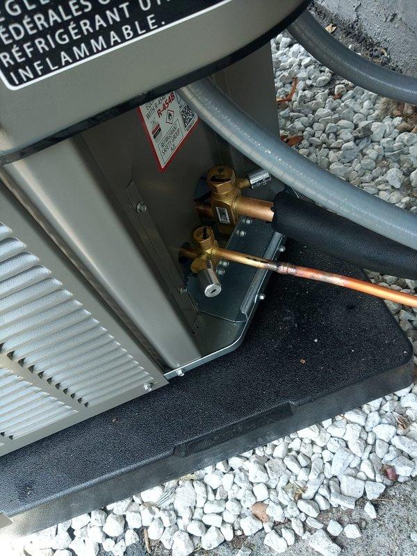 Completed installation of new air conditioning system with matching evaporator coil. Installed dual-element fuse disconnect with Littelfuse Class RK5 20-amp fuses for proper electrical protection. Connected refrigerant lines to outdoor condensing unit with proper insulation on suction line, verified all valve connections and brazed joints for leak-free operation, and set unit on composite pad with proper drainage substrate.