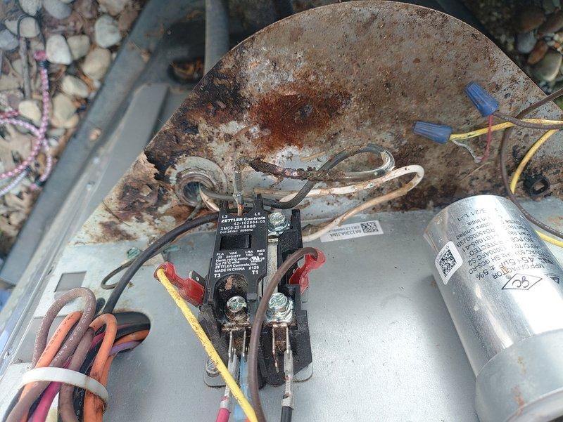 Responded to no-cooling call on a unit less than two years old. Upon arrival, verified system would not start despite customer confirming thermostat settings and fuse were operational. Inspection revealed failed contactor with severely corroded contacts and evidence of moisture intrusion causing premature component failure. Replaced defective contactor, verified all electrical connections, tested system operation, and confirmed unit now cooling properly with normal amperage draw.