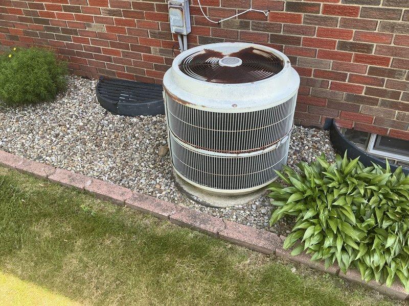 Conducted on-site evaluation for HVAC system replacement at residential property. Assessed existing R-22 air conditioning condenser unit positioned on concrete pad against exterior brick wall, noting age-related deterioration and weathering of components. Evaluated indoor Carrier furnace unit and accompanying ductwork system in basement mechanical room. Documented current equipment specifications, installation conditions, and spatial requirements for replacement system. Provided comprehensive replacement estimate quotes for complete HVAC system upgrade to address obsolete R-22 refrigerant equipment and aging infrastructure.