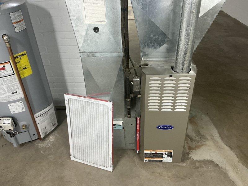Conducted on-site evaluation for HVAC system replacement at residential property. Assessed existing R-22 air conditioning condenser unit positioned on concrete pad against exterior brick wall, noting age-related deterioration and weathering of components. Evaluated indoor Carrier furnace unit and accompanying ductwork system in basement mechanical room. Documented current equipment specifications, installation conditions, and spatial requirements for replacement system. Provided comprehensive replacement estimate quotes for complete HVAC system upgrade to address obsolete R-22 refrigerant equipment and aging infrastructure.