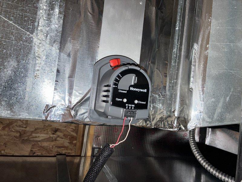 Completed annual cooling system maintenance on a ten-year-old air conditioning unit. Performed comprehensive inspection of all major components including the control board, electrical connections, and zone damper system. Verified proper operation of the Honeywell motorized damper control and confirmed all wiring connections were secure and free from deterioration. Inspected the main control board assembly, checking all relays, capacitors, and wire harnesses for signs of wear or damage. All electrical connections, including multi-colored wire bundles and terminal points, were found to be in good working condition with no visible corrosion or loose connections. System tested and operating within normal parameters.