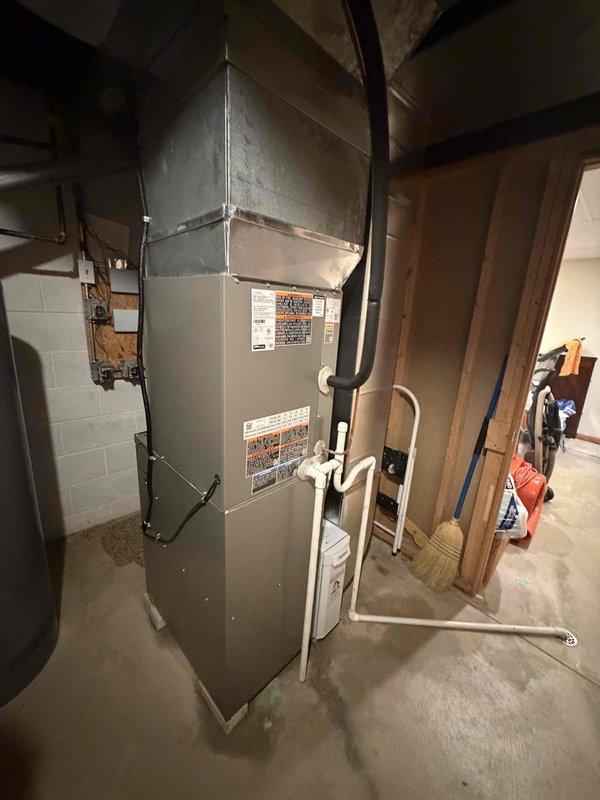 Completed installation of 80% AFUE gas furnace and matching air conditioning system. Installed new indoor air handler unit in basement mechanical room with proper clearances and secured to concrete floor. Mounted outdoor condensing unit on prepared pad with appropriate setback from structure. Ran refrigerant line set between indoor and outdoor components, pressure tested system, evacuated lines, and charged with manufacturer-specified refrigerant. Installed new 30-amp fuses in outdoor disconnect for proper electrical protection. Connected condensate drainage using PVC piping with proper trap and termination. Verified all electrical connections meet code requirements including proper grounding. Tested system operation in both heating and cooling modes, confirmed proper airflow, and verified temperature differentials across coil meet specifications. System operating efficiently within manufacturer parameters.