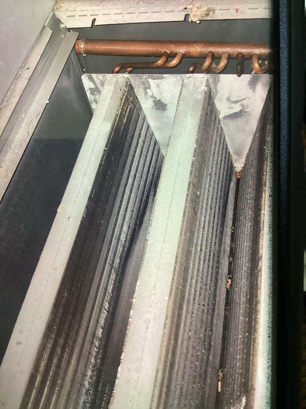 Responded to service call for clogged AC discharge line. Upon inspection, cleared obstruction from condensate drain system to restore proper drainage from evaporator coil. Verified system operation and confirmed condensate flowing freely through drain line upon completion.