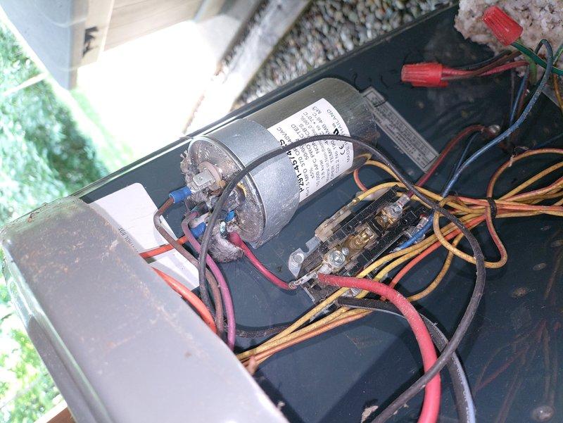 Responded to service call for 13-year-old air conditioning unit running but not producing cold air. Upon inspection, accessed electrical control panel and evaluated capacitor, contactor, and associated wiring connections. All components showed typical age-related wear but appeared functional with proper wire terminations and secure connections to terminal blocks.